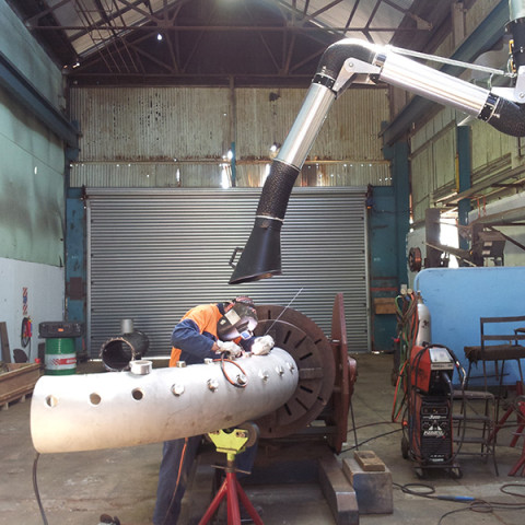 200Ø articulated extraction arm mounted to 4m extension boom. Air volume of 2000m³/hr. Heavy fabrication shop in NZ.